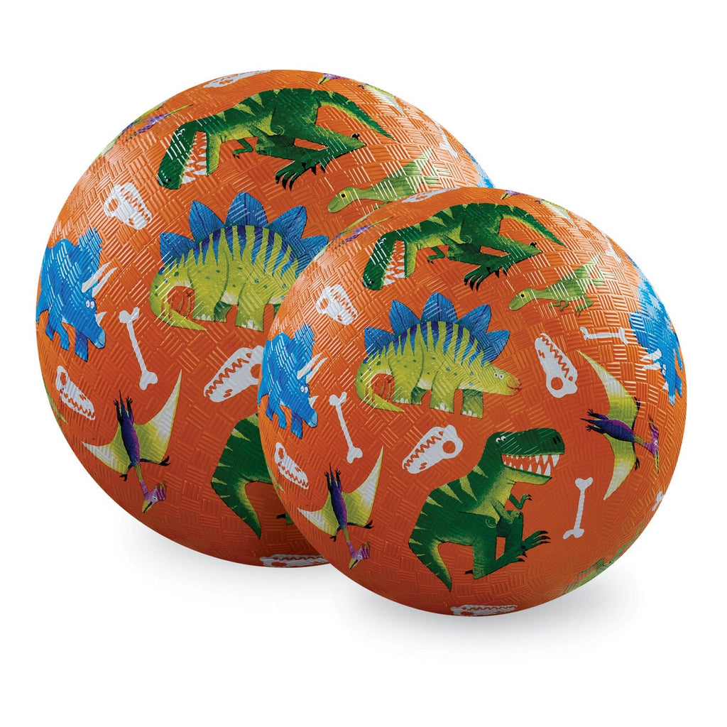 Two orange balls with dinosaur and bone patterns on a white background