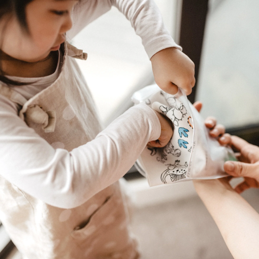 Girl packing away Hey Doodle DinoRoar Colouring mat.