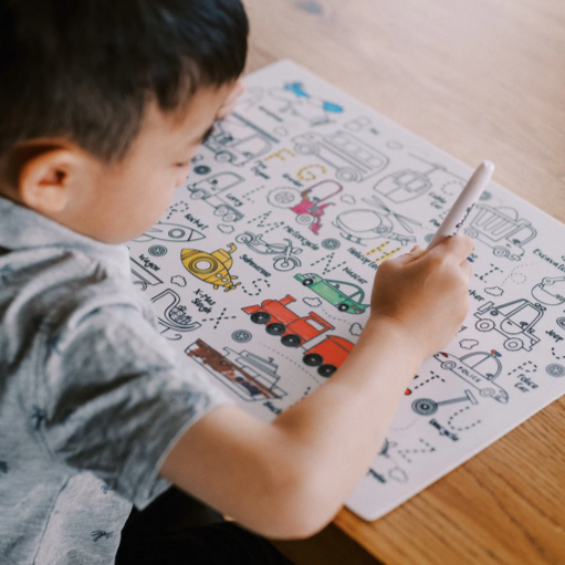 Hey Doodle Hoot Hoot Tonk colouring mat, with boy colouring in.