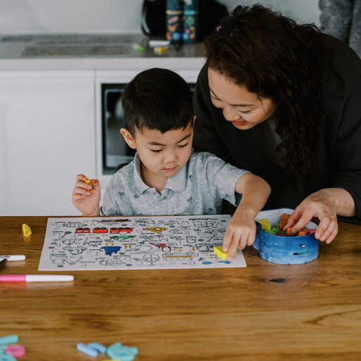 Hey Doodle Hoot Hoot Tonk colouring mat, with boy colouring in.