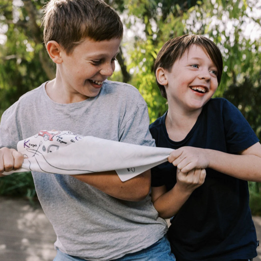 Boys pulling Hey Doodle Hoot Hoot Tonk colouring mat.